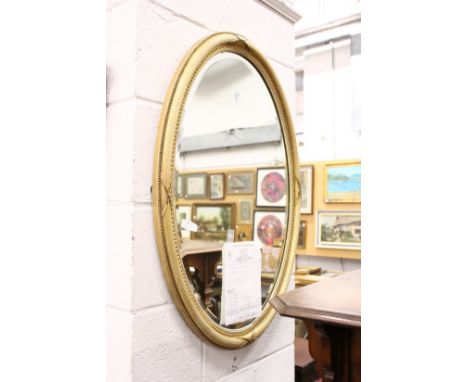 A good oval gilt framed mirror with reeded frame.