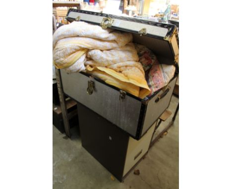 A metal trunk containing eiderdowns together with a two drawer metal filing cabinet.