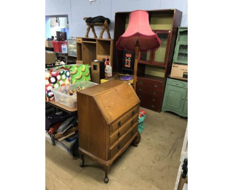An oak bureau and a standard lamp