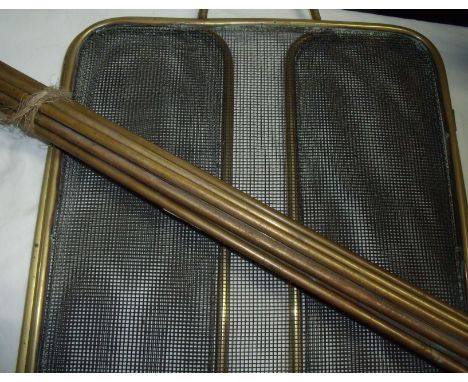 Small three fold brass fire screen and small selection of brass stair rods