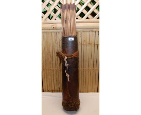 ANTIQUE LEATHER QUIVER FULL OF ARROW SHAFTS 