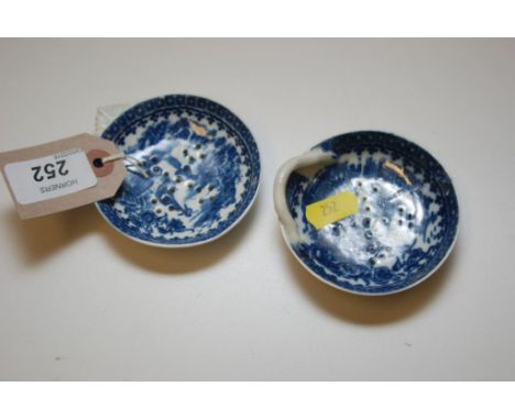 A CAUGHLEY BLUE AND WHITE CIRCULAR STRAINER PRINTED WITH FISHERMEN PATTERN WITH SHELL HANDLE AND ANOTHER SIMILAR WITH STALK H