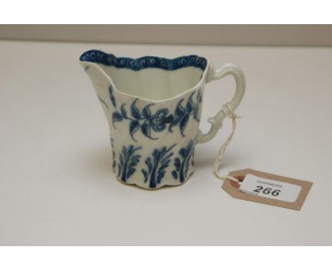 A WORCESTER CREAM JUG OF EWER FORM WITH INNER CELL BORDER, THE EXTERIOR DECORATED WITH FLOWERS AND LEAVES, HEIGHT 9CM 