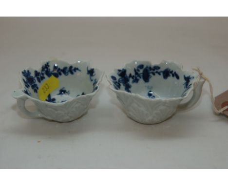 A PAIR OF WORCESTER BLUE AND WHITE BUTTER BOATS PAINTED WITH FLOWERS (ONE WITH FIRING CRACK BOTH WITH RESTORATION) 