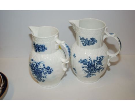 TWO 18TH CENTURY MASKED JUGS, CAUGHLEY PRINTED IN UNDERGLAZE, BLUE WITH FLOWERS, 24 CM AND 22 CM  