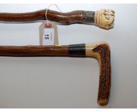 TWO 19TH CENTURY WALKING STICKS, ONE WITH BONE CARVED KNUCKLE KNOB AND SILVER MOUNT ALONG WITH HORN HANDLE SILVER MOUNTED STI