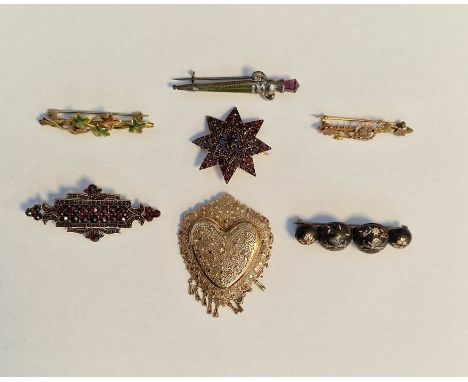Gold-coloured metal and garnet star-shaped brooch, another shaped rectangular, antique gold pique work brooch inset and flora