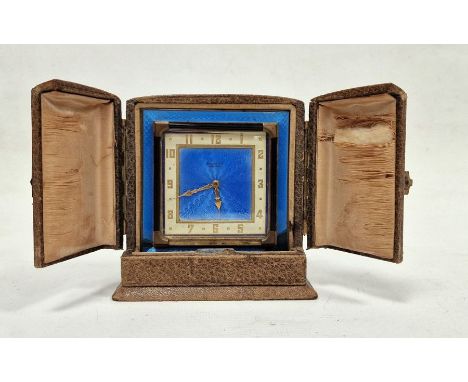 Early 20th century travel clock in original case, the 8 cm square dial with blue enamel, gilt Arabic numerals and&nbsp; hand 