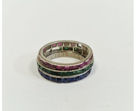 Three white metal eternity-style rings set with sapphire, ruby and emerald (worn, in poor condition and some stones missing) 