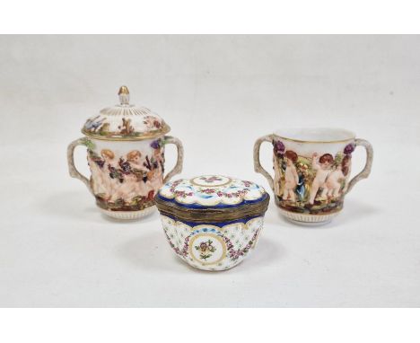Pair Capodimonte porcelain covered two-handled chocolate cups, relief decorated with Bacchanalian cherubs, 12cm high (one wit