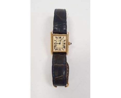 Lady's silver gilt Must de Cartier tank wristwatch with rectangular dial, roman numerals, cabochon sapphire side button and l