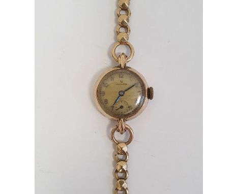 Lady's 9ct gold Rolex wristwatch having Arabic numerals, subsidiary seconds dial and side button and the 9ct gold chain link 