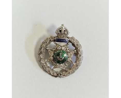 White metal, diamond and enamel regimental brooch, “Rajputana Rifles, Bourbon”, the wreath border and central star set with s