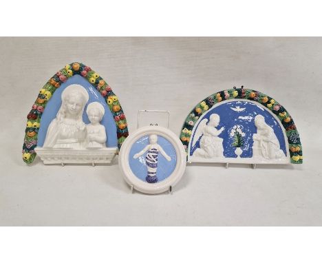 Della Robbia pottery arched shaped plaque, the Annunciation, with fluting border, 32cm wide, similar pointed arch relief head