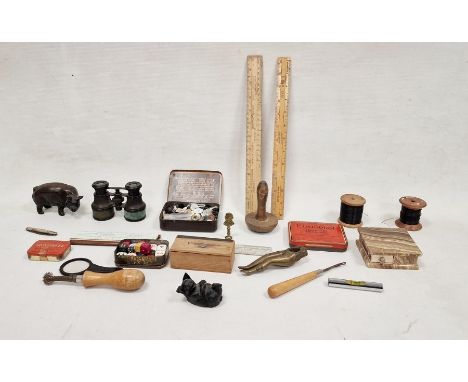 Sock darning mushroom, box of dice, two wooden reels of black thread, two wooden figurines of pigs, vintage boxes for plaster