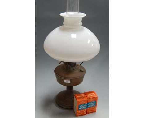 An early 20th century brass pedestal oil lamp, having opalescent glass shade, together with two boxed Aladdin Loxon Mantels, 