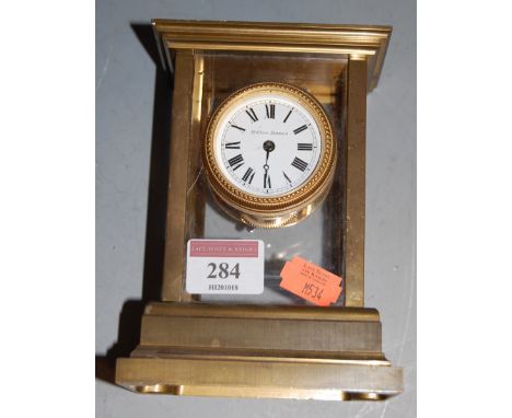 A lacquered brass cased four-glass carriage clock, the circular enamelled dial with Roman numerals, signed Matthew Norman, h.