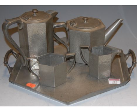 An Arts &amp; Crafts hammered pewter four piece tea and coffee service on tray