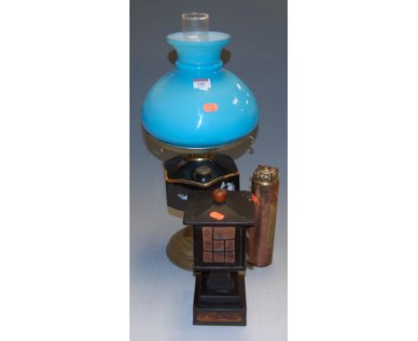 An early 20th century oil lamp; together with a novelty table cigarette dispenser in the form of a lantern; and a Primex copp