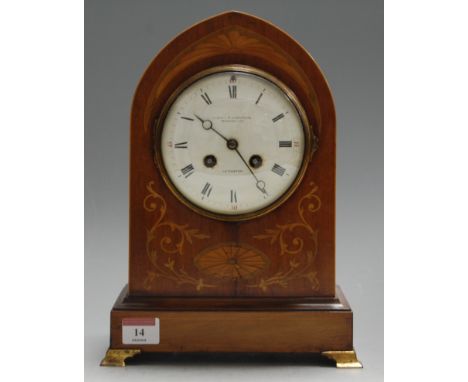 An Edwardian mahogany satinwood and pearwood inlaid mantel clock, of lancet shape, having convex enamelled dial with Roman nu
