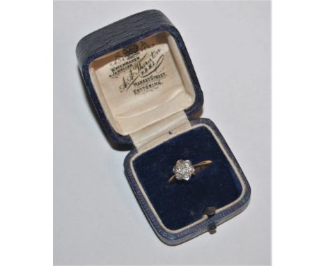 comprised of small round diamonds, (one missing), all set in white metal to a plain band of yellow metal stamped '18ct', size
