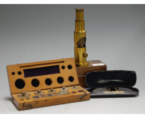 An early 20th century lacquered brass students' monocular microscope, in fitted mahogany case; together with a cased set of p
