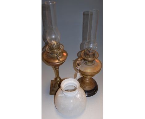 An early 20th century brass pedestal oil lamp having an opalescent shade, together with one other (2)