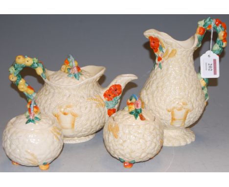 A Clarice Cliff Celtic Harvest teapot and cover; together with a similar jug and two preserve pots and covers (4)