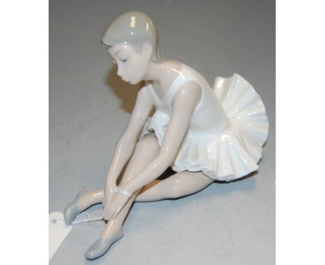 A Nao Spanish porcelain figure of a seated ballerina