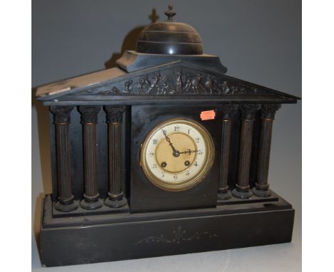 A Victorian black slate mantel clock of architectural form having an enamel dial with Roman numerals and eight day movement, 