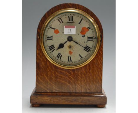 An Edwardian oak cased dome-top mantel clock, having enamelled dial with Roman numerals and Swiss cylinder movement (dial wit