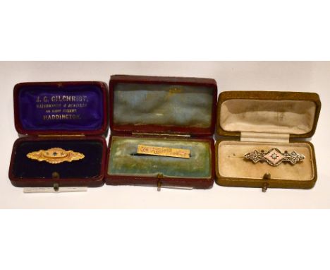 Two Victorian bar brooches, one 9ct set with central blue stone flanked by two clear stones, and a further bar type brooch in