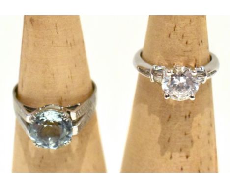 A white metal solitaire ring set with a pale blue stone, possibly topaz, with textured shoulders, size Q, and a 14ct white go