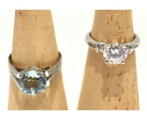 A white metal solitaire ring set with a pale blue stone, possibly topaz, with textured shoulders, size Q, and a 14ct white go