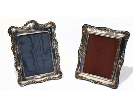PETER VERNON FITCHIE; two Elizabeth II hallmarked Britannia silver easel back photograph frames with cast scrolling detail, L