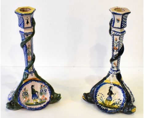 QUIMPER; a pair French tin glazed earthenware candlesticks, with hexagonal shaped sconces and columns, modelled with serpent 