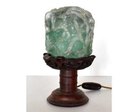 A 20th century Chinese jade style glass shade on turned wooden stand with floral decoration, height 20cm, and a similar jar a