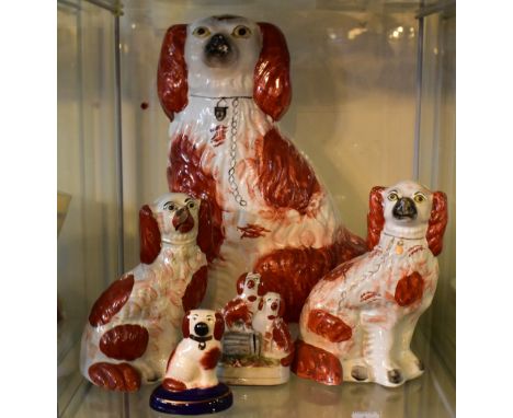 R WOOD; a reproduction Staffordshire figure of a seated male playing the flute beside a seated maiden with animals, height 28