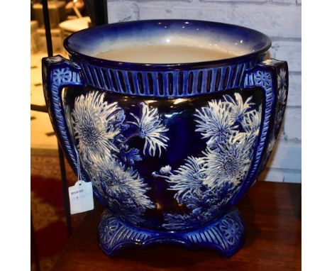 A Victorian ceramic three handled blue and white jardinière with moulded floral decoration, height 32cm, diameter 34cm.Additi
