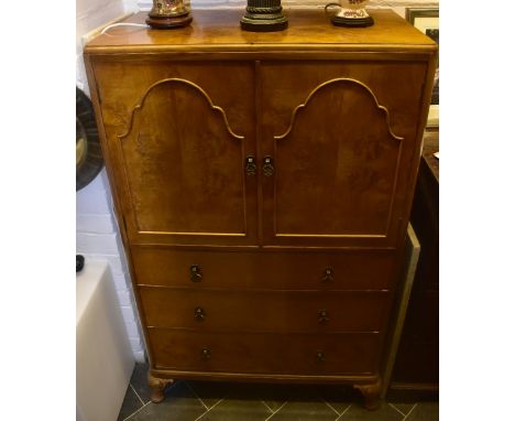 A 1930s walnut tallboy, with a pair of panel doors enclosing single shelf above three drawers, on cabriole supports, width 63