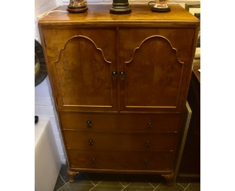 A 1930s walnut tallboy, with a pair of panel doors enclosing single shelf above three drawers, on cabriole supports, width 63