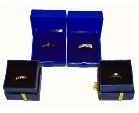 Three 9ct yellow gold dress rings including an illusion set example with central clear stone, size M, and a 9ct white gold dr