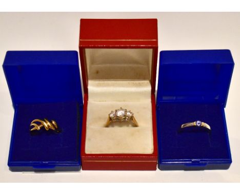 A 9ct yellow gold dress ring set with three glass stones, size S, a ring stamped 14 and a white metal ring stamped 14K (3).Ad