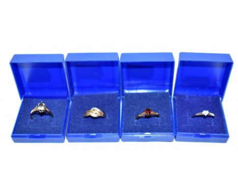 Four 9ct gold dress rings, three examples set with stones including an example set with white stones and garnets, size O, com