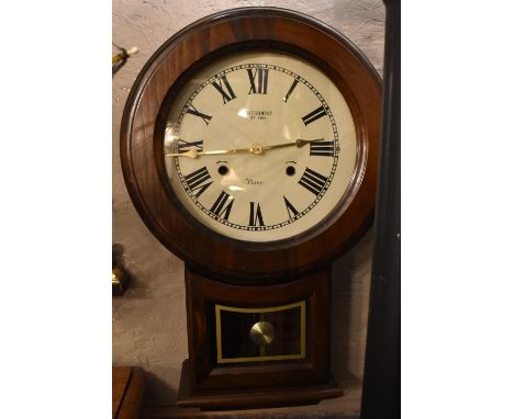 PRESIDENT; a modern stained pine drop dial type wall clock, the circular dial set with Roman numerals, height 48cm.