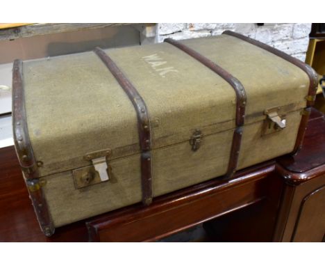 A vintage wooden bound canvas travelling trunk with initials 'W.A.K.'.