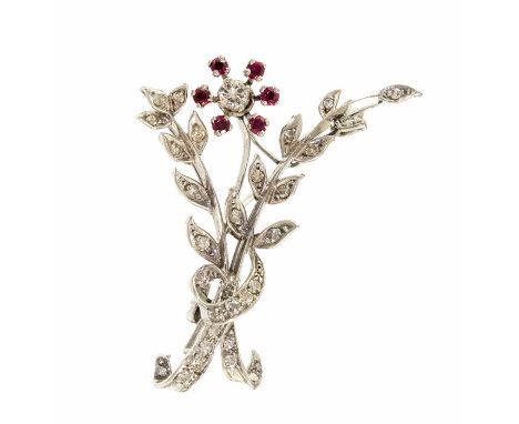 A circa 1950's platinum diamond and ruby set floral spray brooch with eight cut diamonds and brilliant cut diamond to the cen