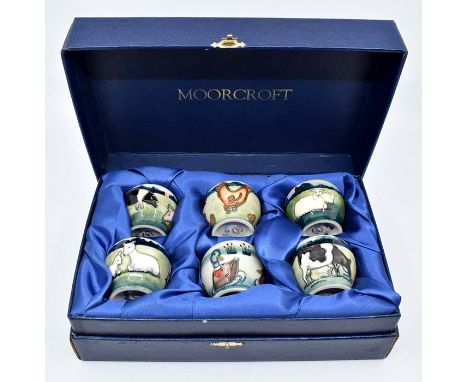 A set of six Moorcroft Farmyard egg cups designed by Anji Davenport, date: 1998, includes goats, ducks, cows, chickens, pigs,
