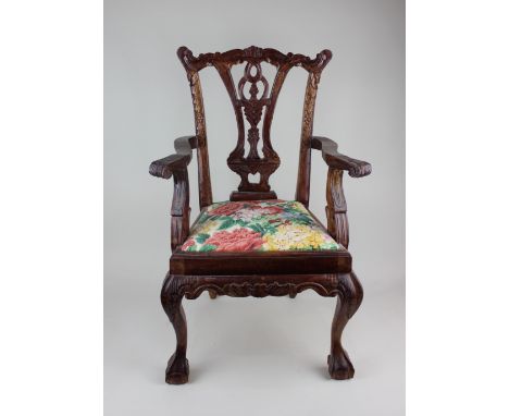 A small Chippendale style elbow chair, with carved and pierced splat back, outswept arms and drop-in seat on cabriole front l