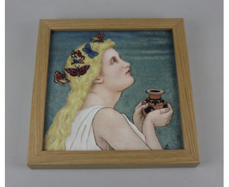A framed Minton portrait tile possibly by Margaret M Armstrong, decorated with a head and shoulders profile of a girl with bu